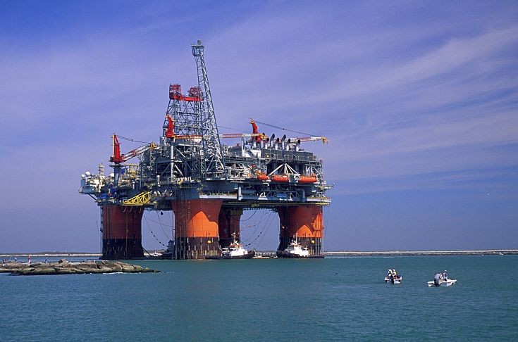 Oil rig with boats.