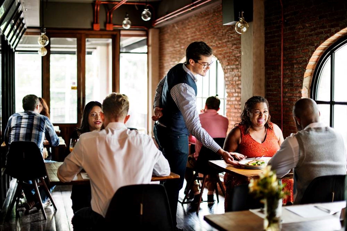 Restaurant with server and customers