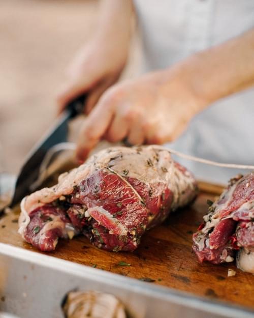 Chef cutting meat in a restaurant kitchen